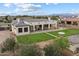 Aerial view of the home showcasing the spacious backyard, covered patio, and beautifully landscaped property at 19717 E Country Meadows Dr, Queen Creek, AZ 85142
