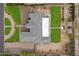 Aerial view showcases large home with intricate roofline, lush lawns, garden and circular driveway at 19717 E Country Meadows Dr, Queen Creek, AZ 85142
