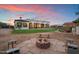 Backyard featuring well-manicured yard and a fire pit perfect for outdoor entertaining at 19717 E Country Meadows Dr, Queen Creek, AZ 85142