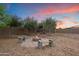 Backyard featuring a cozy fire pit with mature trees giving it a peaceful, shaded spot at 19717 E Country Meadows Dr, Queen Creek, AZ 85142