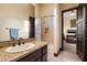 Granite countertop bathroom featuring a shower/tub combo and access to the main bedroom at 19717 E Country Meadows Dr, Queen Creek, AZ 85142