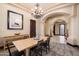 Inviting dining room featuring neutral decor, a modern chandelier, and adjacent archway at 19717 E Country Meadows Dr, Queen Creek, AZ 85142