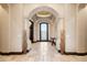 Grand foyer with travertine floors, arched doorways, and decorative niches at 19717 E Country Meadows Dr, Queen Creek, AZ 85142