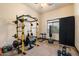Home gym featuring weights, squat rack, and workout equipment providing a personal fitness space at 19717 E Country Meadows Dr, Queen Creek, AZ 85142