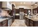Gourmet kitchen features stainless steel appliances, custom cabinetry, and an oversized kitchen island at 19717 E Country Meadows Dr, Queen Creek, AZ 85142