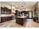 Spacious kitchen with custom cabinets, granite countertops, a large island, and stainless steel appliances at 19717 E Country Meadows Dr, Queen Creek, AZ 85142