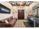 Comfortable office with coffered ceilings, a sofa, and a built-in desk at 19717 E Country Meadows Dr, Queen Creek, AZ 85142