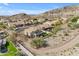 Aerial view of a home with a pool, grassy backyard, mature trees, and desert landscaping in a neighborhood at 2008 E Rock Wren Rd, Phoenix, AZ 85048