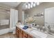 Elegant bathroom with dual sinks, wood cabinets, and shower-tub combination at 2008 E Rock Wren Rd, Phoenix, AZ 85048