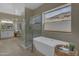 Spa bathroom with freestanding tub and walk-in shower and bright windows at 2008 E Rock Wren Rd, Phoenix, AZ 85048