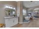 Modern bathroom with double vanity, walk-in shower, and soaking tub at 2008 E Rock Wren Rd, Phoenix, AZ 85048