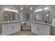 Bright bathroom featuring dual vanities with stone countertops, art, and bench at 2008 E Rock Wren Rd, Phoenix, AZ 85048
