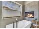 Modern bathroom with soaking tub, fireplace, and mountain views at 2008 E Rock Wren Rd, Phoenix, AZ 85048