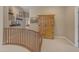 Hallway with a wooden armoire with decorative shelving leading to other living spaces at 2008 E Rock Wren Rd, Phoenix, AZ 85048