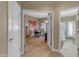Hallway view highlighting access to a home office and a well-appointed bathroom at 2008 E Rock Wren Rd, Phoenix, AZ 85048