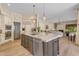 Open kitchen featuring an island with sink, stainless steel appliances, and modern style at 2008 E Rock Wren Rd, Phoenix, AZ 85048