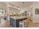 Island kitchen with breakfast bar seating, marble countertops, and pendant lights at 2008 E Rock Wren Rd, Phoenix, AZ 85048