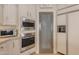 Kitchen featuring stainless steel oven, microwave, and walk-in pantry at 2008 E Rock Wren Rd, Phoenix, AZ 85048