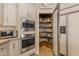 Kitchen featuring pantry with shelving and stainless steel appliances at 2008 E Rock Wren Rd, Phoenix, AZ 85048