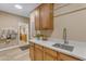 Charming laundry room with wood cabinets, marble countertops, and a convenient sink and faucet at 2008 E Rock Wren Rd, Phoenix, AZ 85048