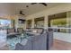 Relaxing covered patio area with wicker furniture, a ceiling fan, and scenic views at 2008 E Rock Wren Rd, Phoenix, AZ 85048