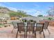 Outdoor patio features a table, chairs, and desert landscaping, creating a tranquil outdoor dining space at 2008 E Rock Wren Rd, Phoenix, AZ 85048