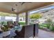 Covered patio with stylish wicker furniture and views of the lush backyard at 2008 E Rock Wren Rd, Phoenix, AZ 85048
