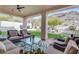 Cozy covered patio featuring comfortable seating and a beautiful view of the lush backyard at 2008 E Rock Wren Rd, Phoenix, AZ 85048