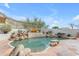 Inviting pool area with rock accents and desert landscaping, creating a tranquil outdoor oasis at 2008 E Rock Wren Rd, Phoenix, AZ 85048