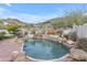 Beautiful backyard pool with rock features, surrounded by desert landscape, perfect for relaxation and entertaining at 2008 E Rock Wren Rd, Phoenix, AZ 85048