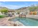Inviting backyard pool with rock waterfall feature and ample space for outdoor seating at 2008 E Rock Wren Rd, Phoenix, AZ 85048