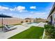 Expansive backyard featuring a sparkling pool, artificial turf, and lounge chairs for outdoor enjoyment at 22372 E Duncan St, Queen Creek, AZ 85142