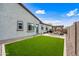 Well-manicured backyard with a modern pergola, lush artificial grass, and gravel landscaping offering a serene outdoor space at 22372 E Duncan St, Queen Creek, AZ 85142