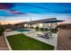 Stunning backyard features a pool, lounge chairs, and manicured landscaping at sunset at 22372 E Duncan St, Queen Creek, AZ 85142