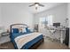 Cozy bedroom with a large window, ceiling fan, and comfortable bed with stylish bedding at 22372 E Duncan St, Queen Creek, AZ 85142