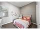 Cozy bedroom with a neutral color palette and a charming accent wall at 22372 E Duncan St, Queen Creek, AZ 85142