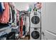 Walk-in closet featuring shelving and stacked washer and dryer units at 22372 E Duncan St, Queen Creek, AZ 85142