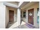 Inviting entryway with dual front doors, stylish mats, decorative windows, and neutral stucco wall at 22372 E Duncan St, Queen Creek, AZ 85142