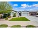 Charming home featuring a well-manicured lawn, mature landscaping, and a one-car garage enhancing curb appeal at 22372 E Duncan St, Queen Creek, AZ 85142