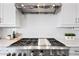 A close-up shot of a kitchen's stainless steel oven, with a pristine white-tiled backsplash at 22372 E Duncan St, Queen Creek, AZ 85142