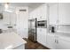 Bright kitchen features white cabinetry, stainless steel appliances and a large island at 22372 E Duncan St, Queen Creek, AZ 85142