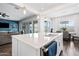 Open kitchen with a large island, stainless steel appliances, seamlessly connecting to the living and dining areas at 22372 E Duncan St, Queen Creek, AZ 85142