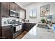 Modern kitchen features stainless steel appliances, granite countertops, and ample cabinet space at 22372 E Duncan St, Queen Creek, AZ 85142
