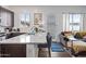 Open concept kitchen with breakfast bar and seating that connects to the living room at 22372 E Duncan St, Queen Creek, AZ 85142