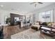 Open-concept living room and kitchen with hardwood floors and ample natural light at 22372 E Duncan St, Queen Creek, AZ 85142