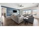 Spacious living room featuring modern decor, tile flooring, a large TV, and ample seating for relaxation at 22372 E Duncan St, Queen Creek, AZ 85142