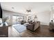 Open-concept living room with tile floors, comfortable seating, and sliding glass doors leading to the pool area at 22372 E Duncan St, Queen Creek, AZ 85142