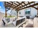 Under the pergola, enjoy a relaxing outdoor living space with comfortable seating and stylish decor at 22372 E Duncan St, Queen Creek, AZ 85142