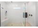 Luxurious walk-in shower with a glass enclosure, tiled walls, and multiple shower heads at 22372 E Duncan St, Queen Creek, AZ 85142