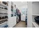 Spacious walk-in closet with custom shelving, drawers, and ample storage space at 22372 E Duncan St, Queen Creek, AZ 85142